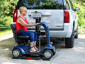 Woman riding a mobility scooter off the Bruno Out-Sider